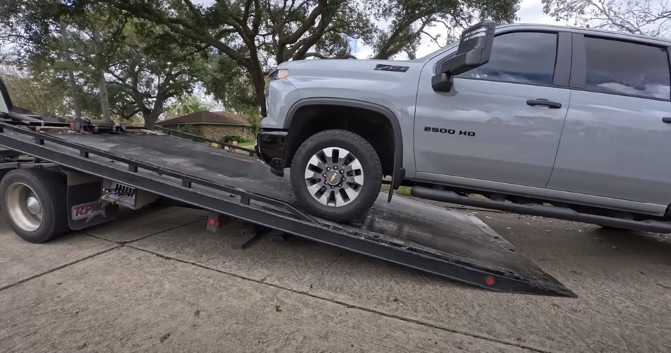 Flatbed towing service safely loading pickup truck in Norwalk